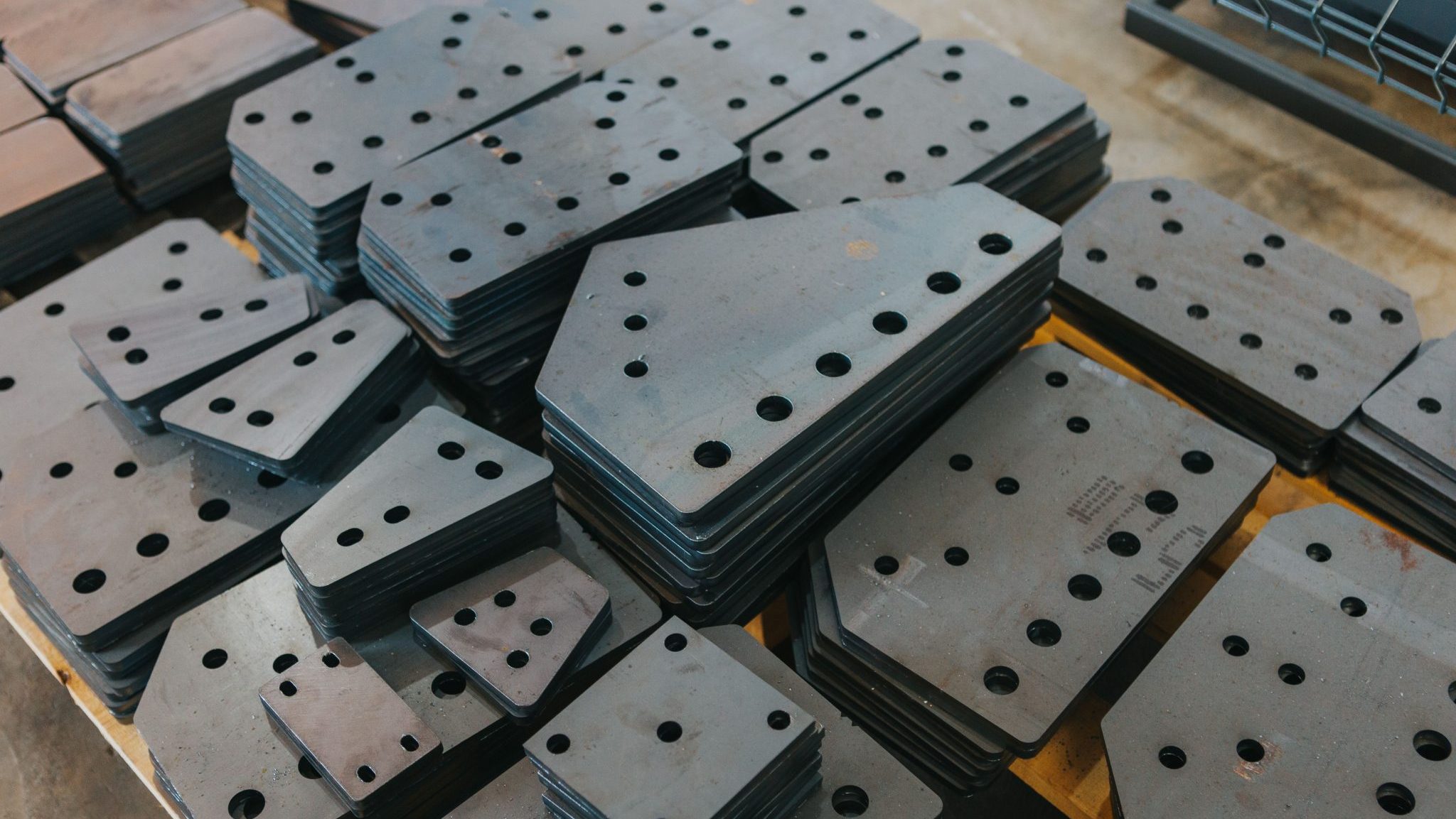Bunch of different kinds of connecting plates stacked in neat piles
